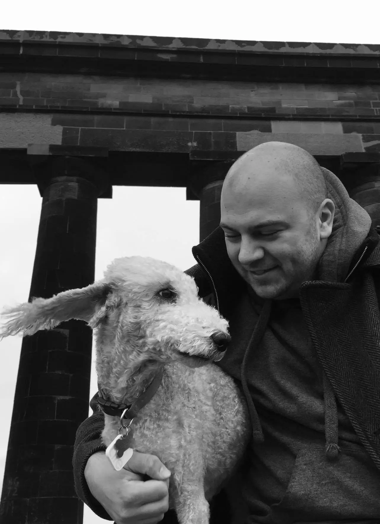 Black and white photo of Jez with his dog.