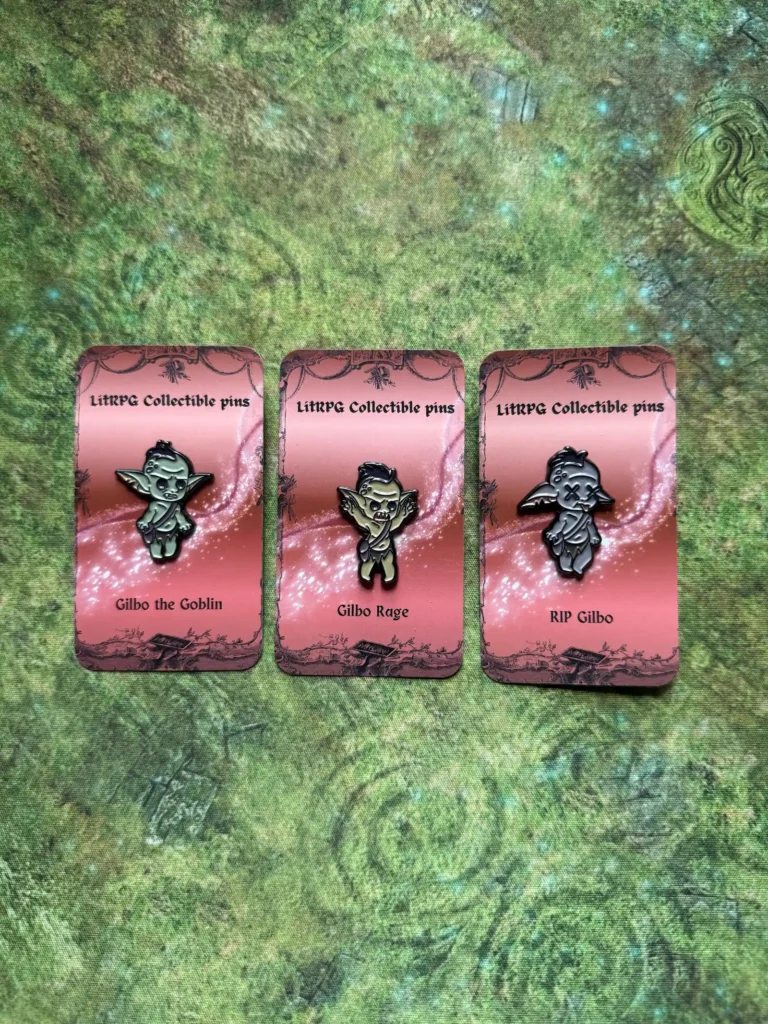 Gilbo the Goblin, Gilbo Rage and RIP Gilbo collectible pins on a green mat